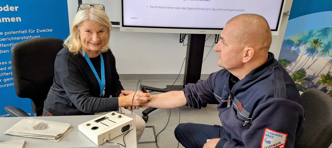 UV Schutztag Flughafen Graz 1440 Credit Markus Lippitsch Arbeitsmedizinerin untersucht Haut eines Teilnehmers